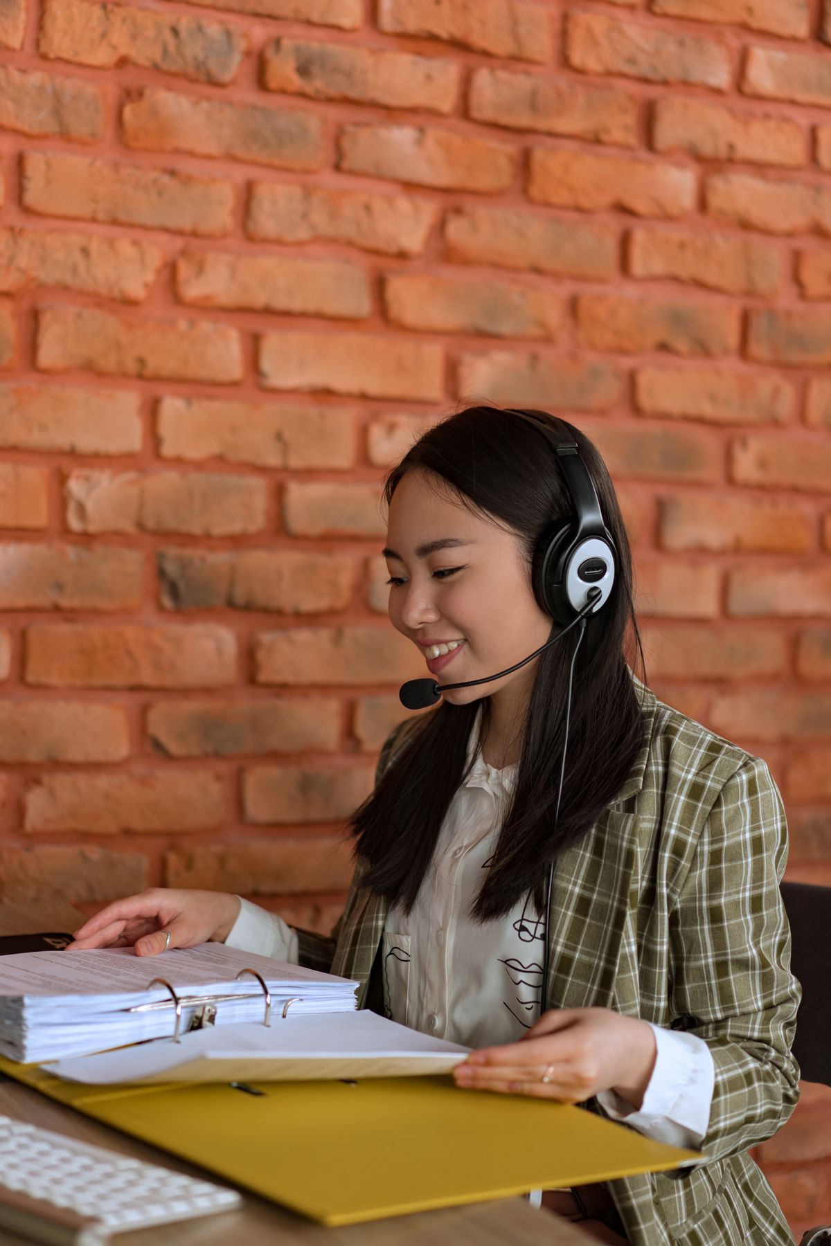 Account manager wearing a headset assisting a client